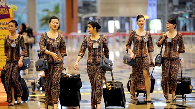 Singapore Girls ... Singapore Airlines flight attendants will now be able to serve for three more years.