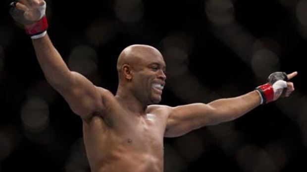 Anderson Silva celebrates after beating Vitor Belfort to retain the UFC middleweight world title.