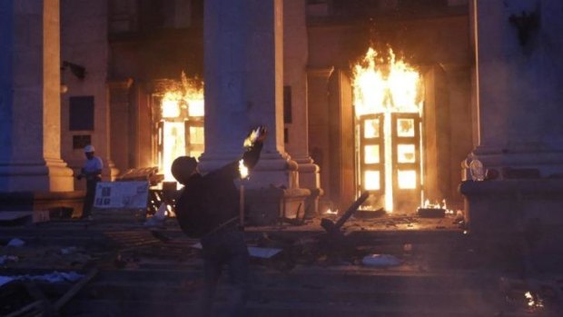 Deadly assault ... A protester throws a petrol bomb at the trade union building in Odessa.