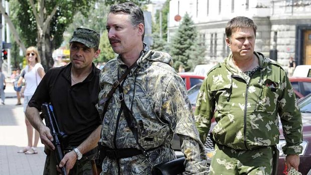 Self-proclaimed minister of defence of the so-called "Donetsk People's Republic" Igor Girkin, centre, walks with his bodyguards in the eastern Ukrainian city of Donetsk earlier this month.