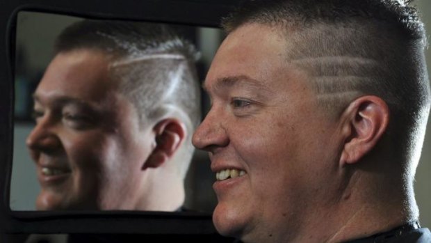 Tennis ACT CEO Ross Triffitt has a "Kyrgios" hair cut as part of a bet with the tennis player. Hairdresser, Craig Rhodes of Smitten Hairdressing in Tuggeranong, performed the work.