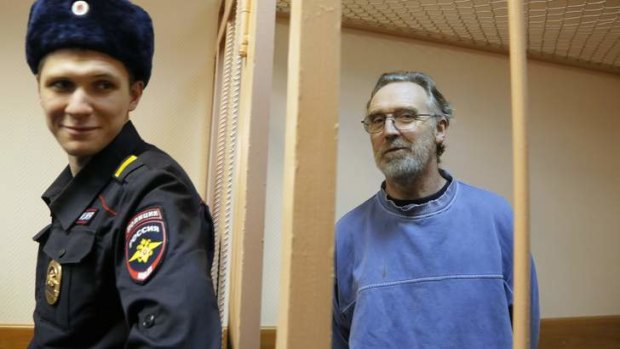 Greenpeace International activist Colin Russell of Australia stands in a cage during a court hearing to consider the request to extend the detention of 30 members of the Arctic Sunrise Greenpeace International ship in St. Petersburg, Russia, Monday, Nov. 18, 2013.