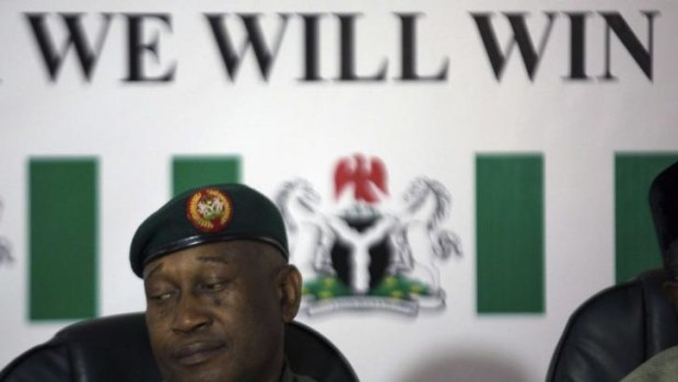 In control?: Nigerian army spokesman Major-General Chris Olukolade sits in front of a poster reading "We Will Win" in Abuja on Monday.