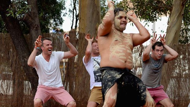 Walk this way: England's Graeme Swann (left) and Jonny Bairstow perform with Wakagetti cultural dancers during a visit to Uluru.