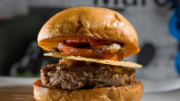 The signature burger at Umami Burger in Costa Mesa is the Umami burger which includes ground beef, shiitake mushroom, caramelized onions, roasted tomato, parmesan crisp and umami ketchup.