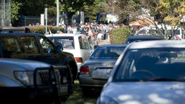 Cars parked on Manuka Circle as hoards of people enter the Giants game at Manuka Oval in April last year.