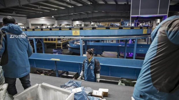 A ZTO Express sorting facility in Shanghai: The battle for market dominance takes a toll on workers, many of whom work 12-hour shifts, six or seven days a week 