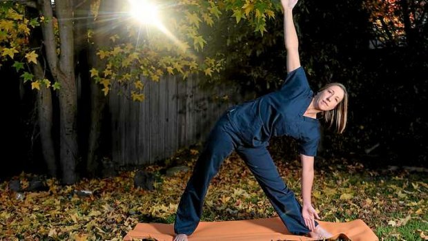 Intensive care nurse Sam Breguet practises yoga in her Geelong backyard. She says patients' health is jeopardised by fatigue among nursing staff.