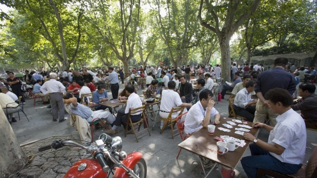 Card players gather for a game or two at Fuxing Park in Shanghai.