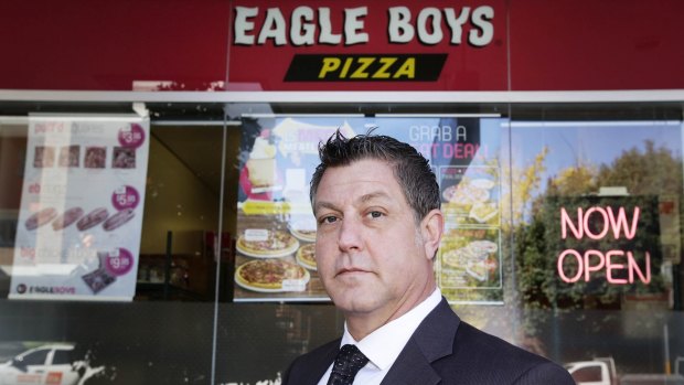 Business consultant Alan Noor poses outside Eagle Boys Pizza in Ryde. Mr Noor is suing the company after it sent an email allegedly defaming him to all its franchisees. 