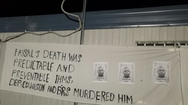 A sign at a memorial service for Faysal Ahmed on Manus Island.