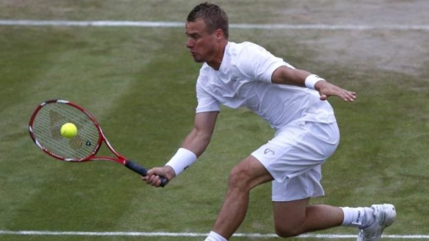 Lleyton Hewitt in action against Jerzy Janowicz of Poland during their men's singles match at Wimbledon. Play was suspended due to rain.