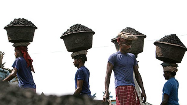 Carrying coal in Gauhati, India. An energy supply shortage could compromise plans to expand the economy and cut poverty.
