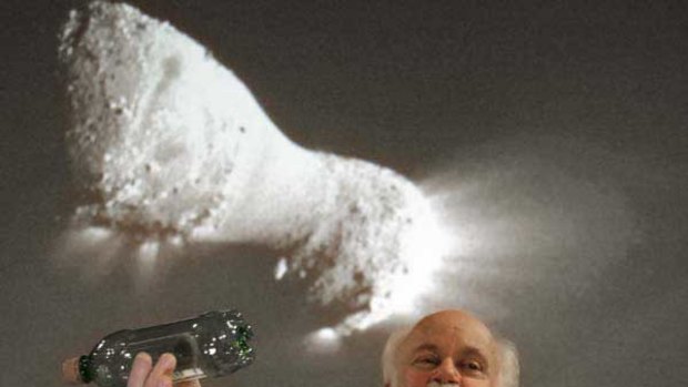 Scientist Michael A’Hearn beneath an image of the comet.