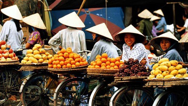 Fresh food people ... footpath snacking and market shopping several times a day are part of life in the Vietnamese capital, Hanoi.