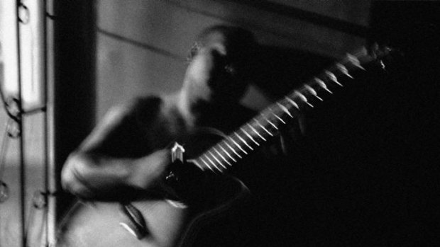 "Johnny playing guitar, Port Moresby, PNG" by Sean Davey.