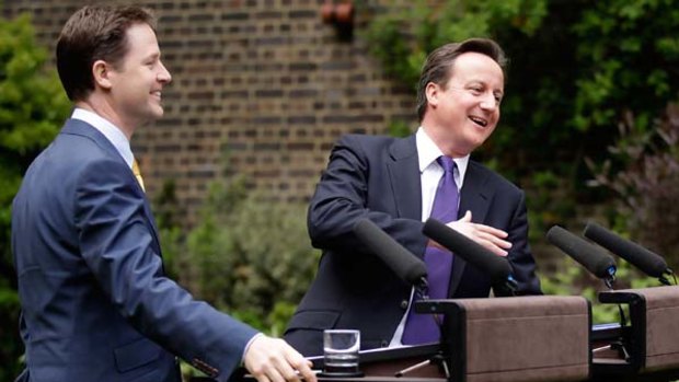 David Cameron and Nick Clegg share a joke at their first joint press conference in the Downing Street garden.