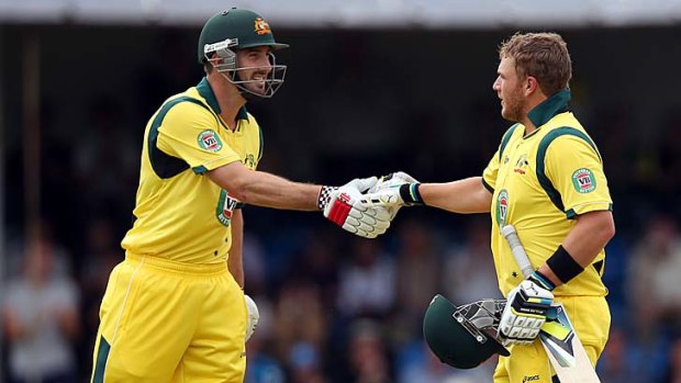 Australia's Aaron Finch (R) is congratulated by teammate Shaun Marsh upon scoring his century.