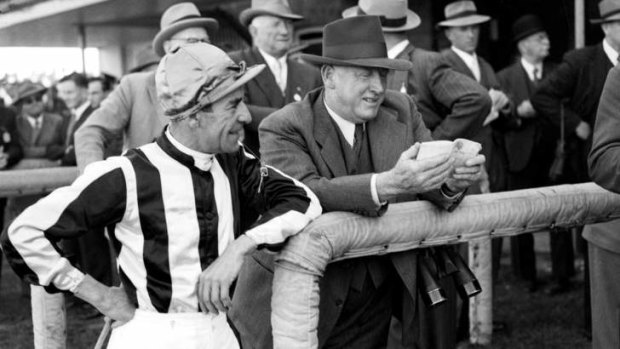 Jockey Darby Munro pictured with trainer Ted Hush at Sydney's Rosehill Racecourse on 22 September 1952, before their mount Hydrogen won the Hill Stakes. Later in the year the three would combine again to win the Cox Plate.