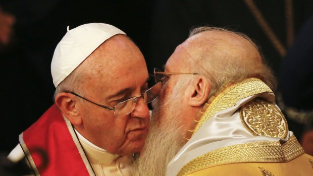 Ecumenical Patriarch Bartholomew I of Constantinople embraces Pope Francis during the service in Istanbul.