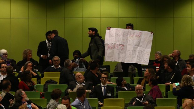 Protesters in the audience at the Labor national conference.