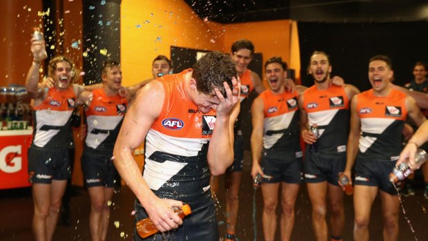 Hop to it: Jacob Hopper of the Giants is sprayed by teammates after GWS's win over the Gold Coast Suns at Spotless Stadium on Saturday.