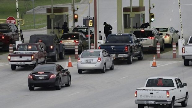 Security guards check vehicles as they enter Fort Hood's main gate on Thursday.