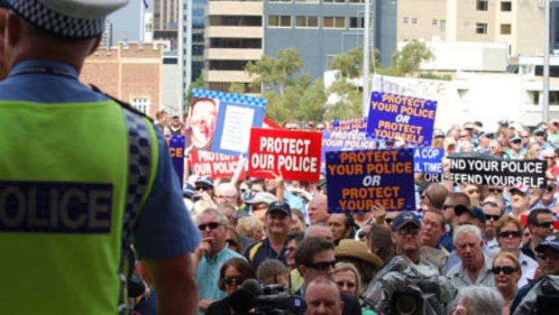 Officers and members of the public rally at Parliament House in support of police on the front line.