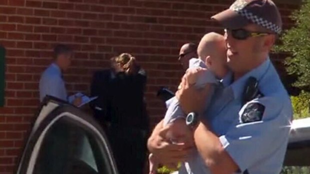 A police officer with the baby. <em> Photo: Courtesy Nine News </em>