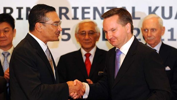 Malaysia's home affairs minister Hishammuddin Hussein (left) and Immigration Minister Chris Bowen during negotiations to send asylum seekers to Malaysia and accept 400 refugees from that country over four years.