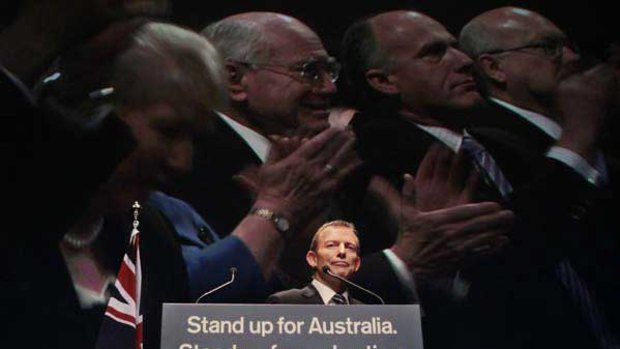 Tony Abbott launches the Coalition's campaign while images of the party faithful, including former prime minister John Howard, appear to be on the screen behind him. <i>Picture: Glen McCurtayne</i>