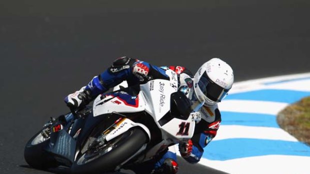 Living on the edge ... Troy Corser pilots his BMW around Phillip Island during qualifying yesterday.