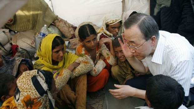 "Heart-wrenching" . . . the UN Secretary-General, Ban Ki-Moon, speaks with orphaned children in a displaced persons' camp in Punjab province yesterday. The scale of the disaster is unprecedented.