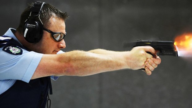 A Victoria Police officer tests the new Smith & Wesson. Protective services officers will receive about eight weeks’ training.
