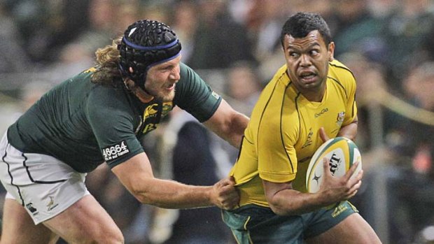Frans Steyn tackles rival fullback Kurtley Beale furin the Tri Nations Test in Durban on Saturday.