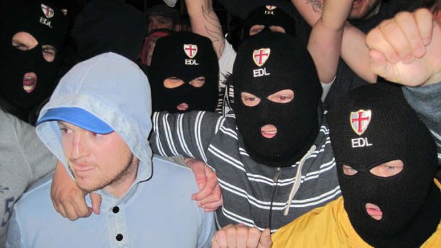 The leader of the English Defence League leader, Tommy Robinson, left, with supporters in Woolwich after the attack.