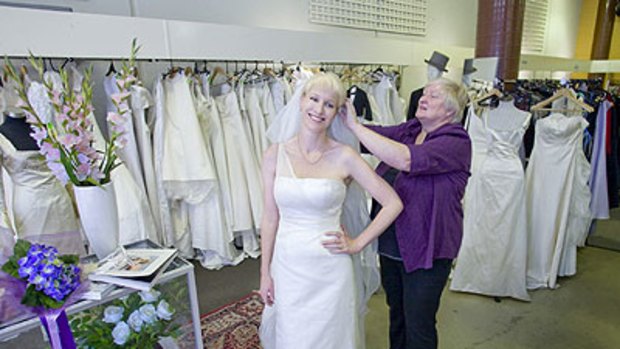 Pre-loved ... Cheryl Rowlands’s mum, Annette, helps with her gown at Melbourne’s specialty Salvos store.