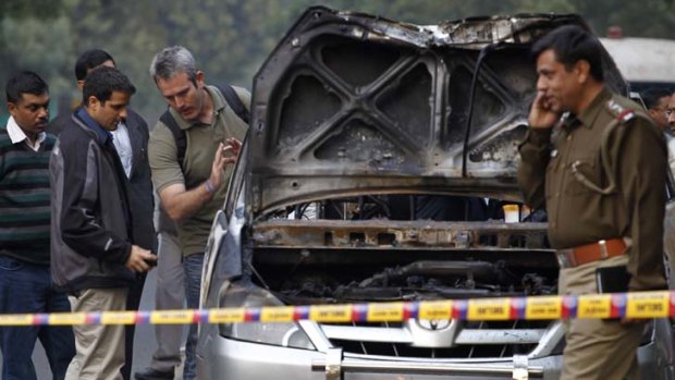 Clues ... men believed to be from the Israeli embassy inspect the site of the car bomb attack that injured a diplomat's wife, a driver and two passers-by in Delhi.