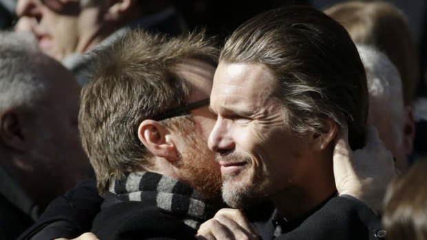 Ethan Hawke, right, exchanges a hug with an unidentified man following the funeral of actor Philip Seymour Hoffman at the Church of St. Ignatius Loyola, Friday, Feb. 7, 2014 in New York.