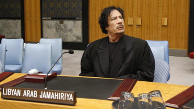 (Top) Libyan leader Muammar Gaddafi takes a seat during a visit to the United Nations headquarters in New York yesterday, and (bottom) a tent pitched for Gadhafi in Rome in June.