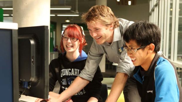 Pause for thought ... Gungahlin College teacher Peter Smythe helps students Hayley Stensholt and Huan Tran.