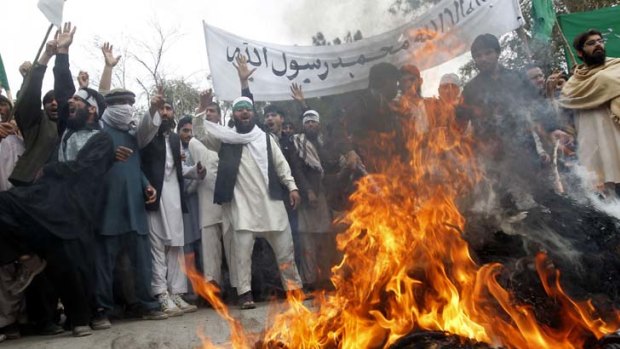 Afghans burn an effigy of US President Barack Obama during a demonstration against the shooting of at least 16 villagers by a US Army staff sergeant.