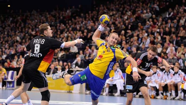 Friendly fire ... Mattias Gustafsson of Sweden is challenged by Sebastina Preiss and Christian Sprenger of Germany during a friendly.