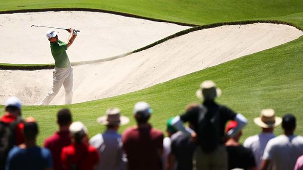 Adam Scott finds his way out of a bunker on the sixth.