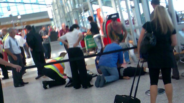 Airport staff  and members of the public try to revive Anthony Zervas.