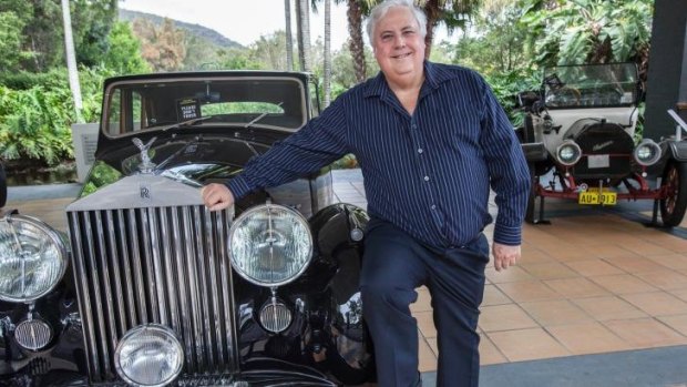 Playing the game: Clive Palmer, pictured with a car from his vast collection, had been driving through his electorate when he called in to the radio quiz.