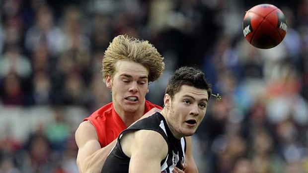 Marty Clarke battles with Melbourne's Jack Watts.