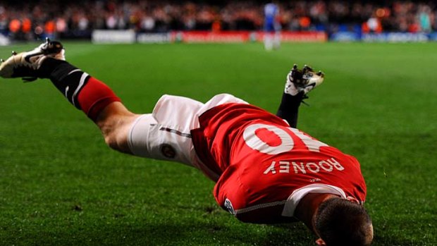 Stunner ... Wayne Rooney hits the turf in celebration.