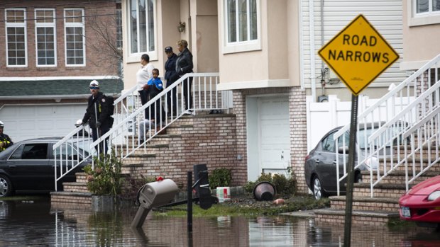 Nightmare ... Rescue workers check a flooded home for fuel leaks and other types of storm-related damage on Staten Island