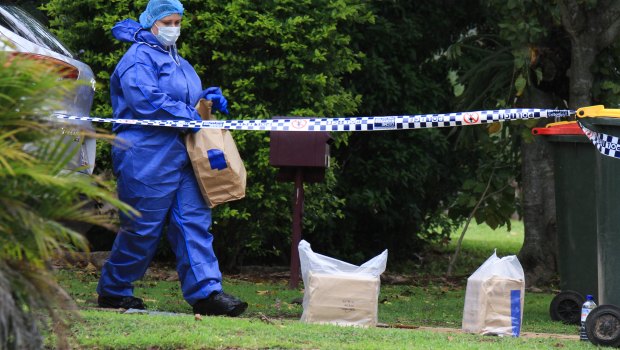 Police collect evidence at a home in The Gap, where a baby was allegedly attacked on Tuesday morning.